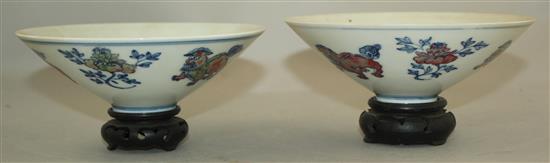 A pair of Chinese underglaze blue and copper red conical bowls, Jiajing marks, late 19th / early 20th century, 15.5cm, wood stand